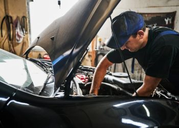 Man working on a car's engine.