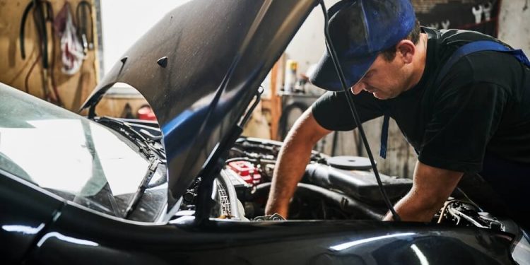 Man working on a car's engine.