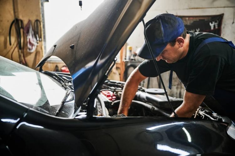 Man working on a car's engine.