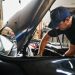 Man working on a car's engine.