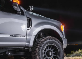 Side profile of an F250 with a lift kit and aftermarket parts and wheels.
