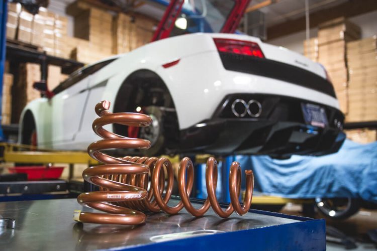Gold performance suspension springs with white Lamborghini Gallardo.