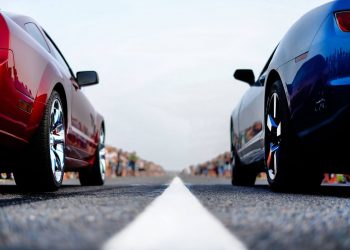 A Mustang and a Camaro lined up to drag race