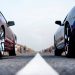 A Mustang and a Camaro lined up to drag race