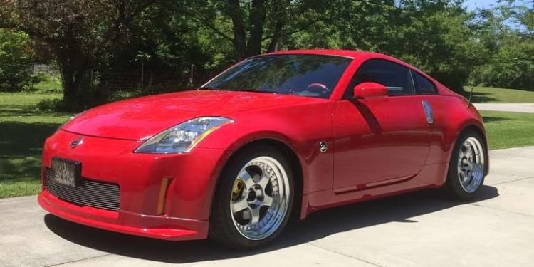 A red Nissan 350z in a driveway