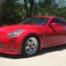 A red Nissan 350z in a driveway