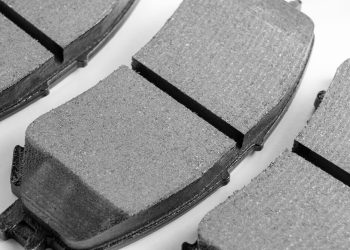 A set of vehicle brake pads against a white background.